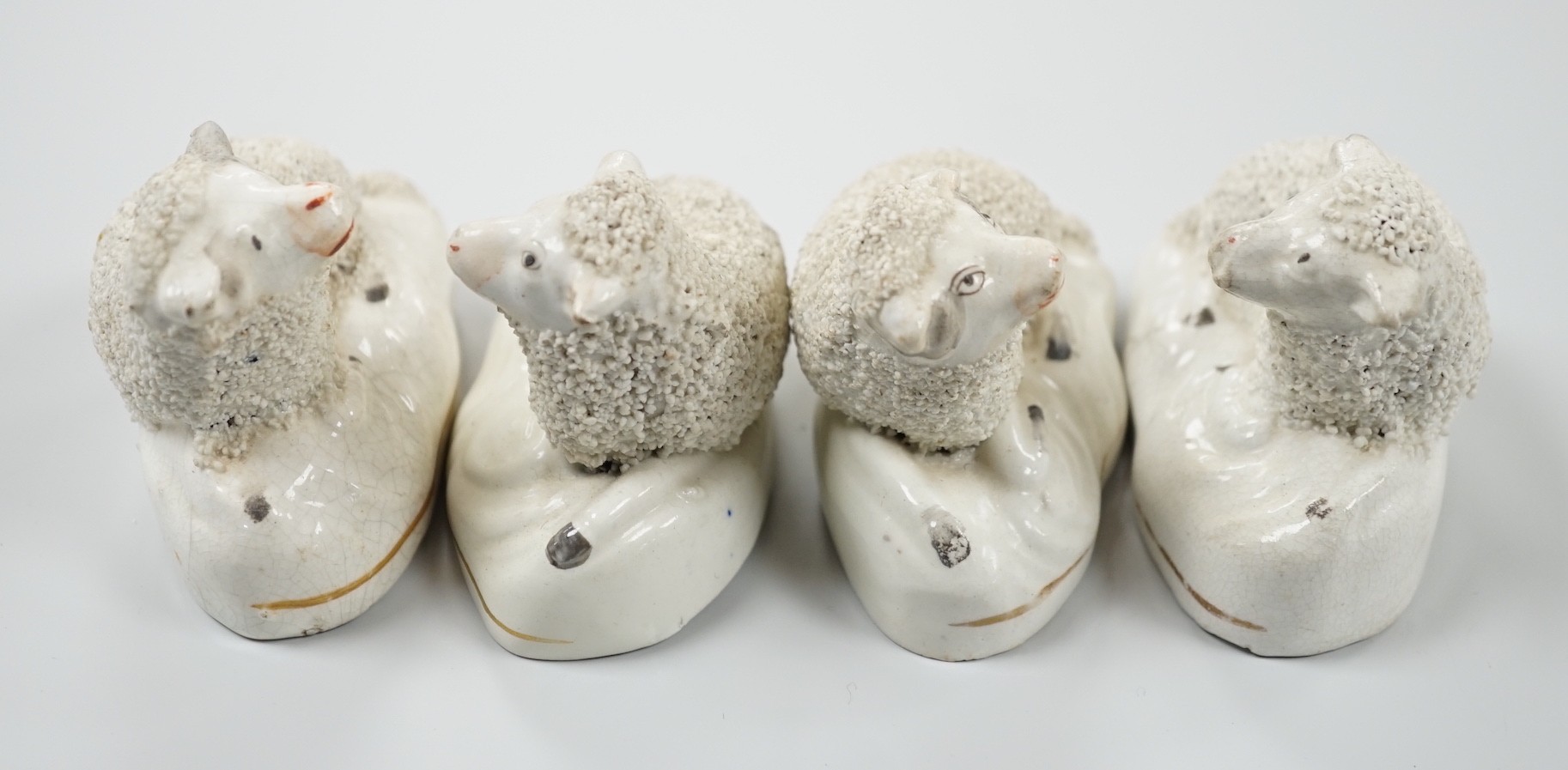 Four small Staffordshire models of recumbent sheep, c.1830-50. 8.5cm long, Provenance: Dennis G.Rice collection